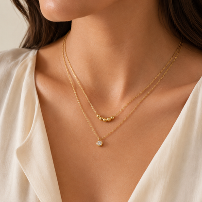 Collar Doble Dorado con Dije y Esferas